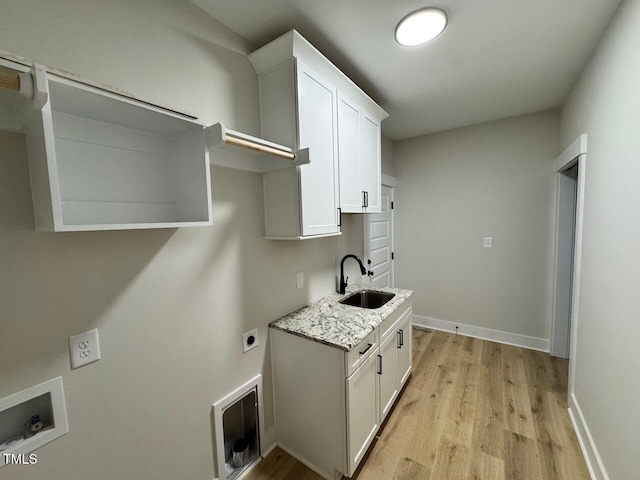 27 Batten Hill Ln, Selma, NC 27576 - laundry area with cabinet space, hookup for an electric dryer, light wood finished floors, and hookup for a washing machine