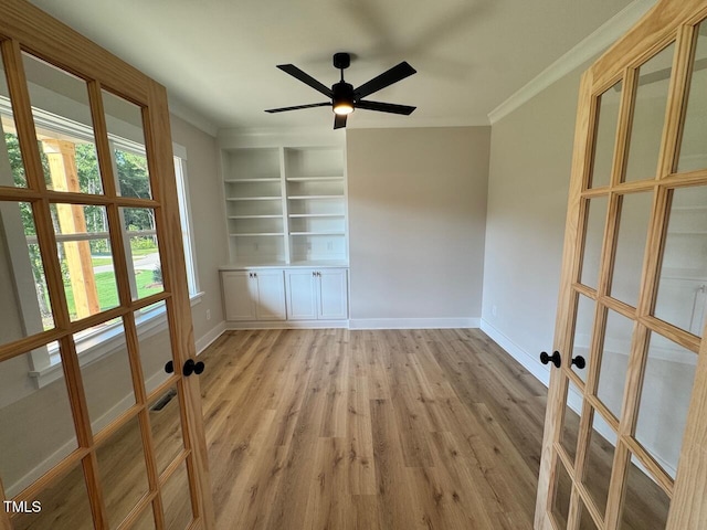 27 Batten Hill Ln, Selma, NC 27576 - spare room with wood finished floors, crown molding, french doors, built in features, and a ceiling fan