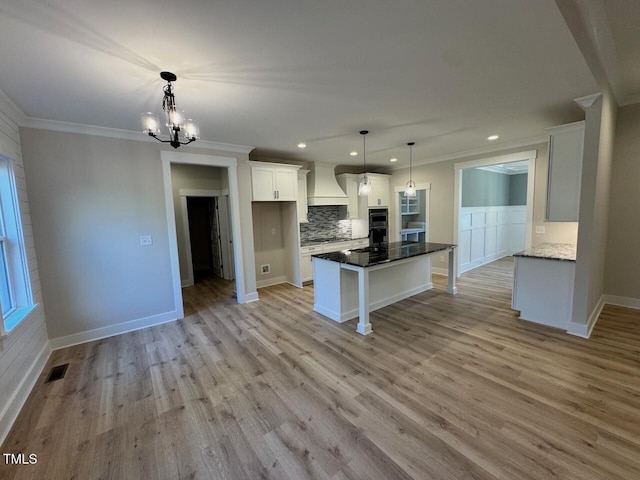 27 Batten Hill Ln, Selma, NC 27576 - kitchen with custom range hood, ornamental molding, decorative backsplash, white cabinetry, and recessed lighting