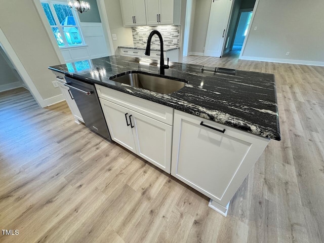 27 Batten Hill Ln, Selma, NC 27576 - kitchen featuring light wood-type flooring, stainless steel dishwasher, white cabinets, and dark stone counters