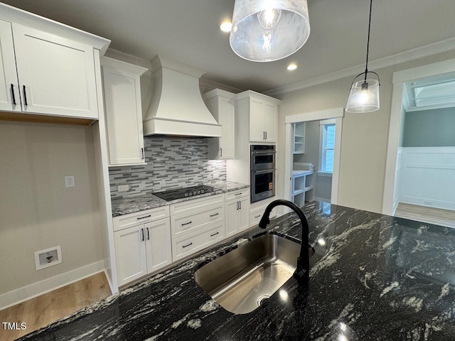 27 Batten Hill Ln, Selma, NC 27576 - kitchen featuring custom exhaust hood, black electric cooktop, decorative backsplash, white cabinetry, and ornamental molding