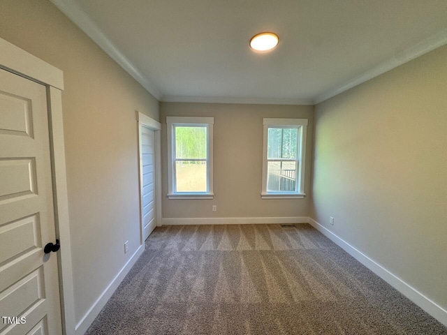 27 Batten Hill Ln, Selma, NC 27576 - spare room featuring carpet flooring and crown molding
