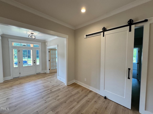 27 Batten Hill Ln, Selma, NC 27576 - foyer featuring a barn door, ornamental molding, light wood-type flooring, and recessed lighting