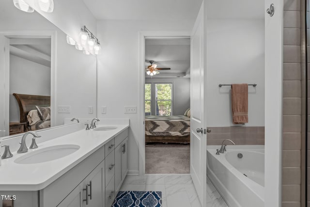 ensuite bathroom with a sink, marble finish floor, a ceiling fan, and ensuite bath
