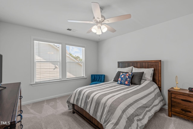carpeted bedroom featuring baseboards, ceiling fan, and visible vents