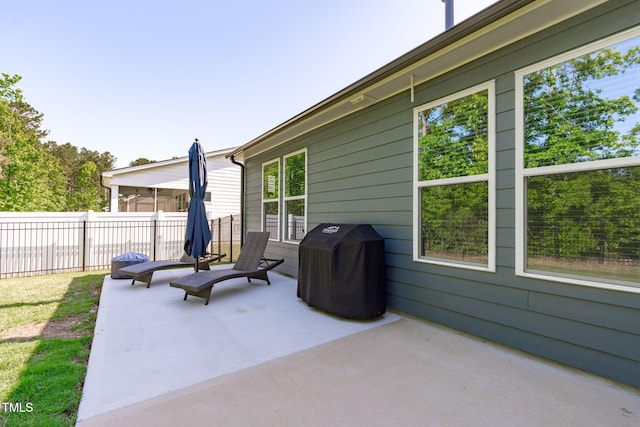 view of patio / terrace featuring area for grilling and fence