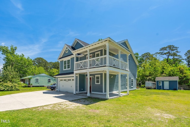 view of front of home featuring a storage unit, an attached garage, a front lawn, a balcony, and driveway