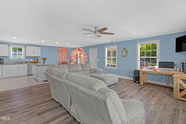 living area featuring recessed lighting, ceiling fan, plenty of natural light, and light wood-style floors