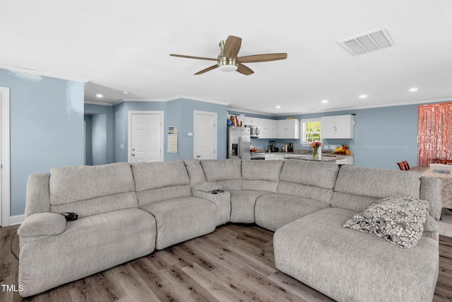 living area featuring visible vents, recessed lighting, and light wood-style flooring