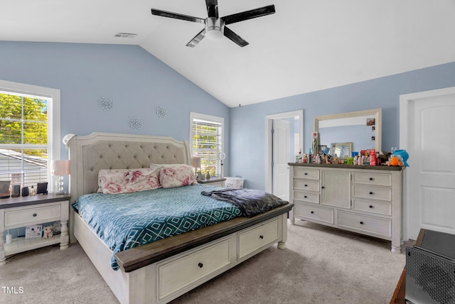 bedroom featuring ceiling fan, vaulted ceiling, light colored carpet, and visible vents