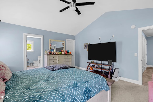 bedroom with ceiling fan, vaulted ceiling, baseboards, ensuite bathroom, and carpet