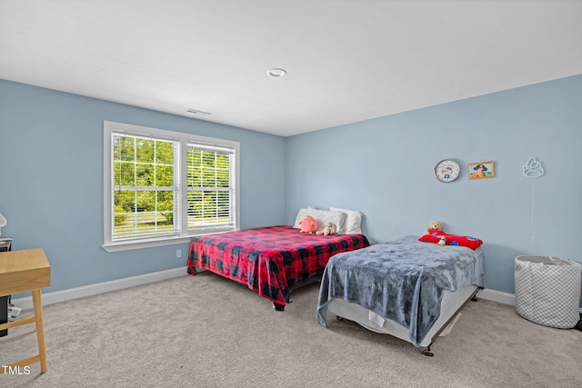 bedroom featuring baseboards and carpet flooring
