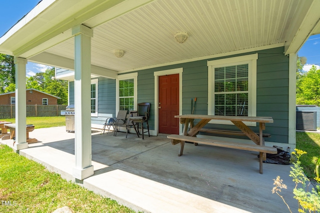 view of patio / terrace with central AC and fence