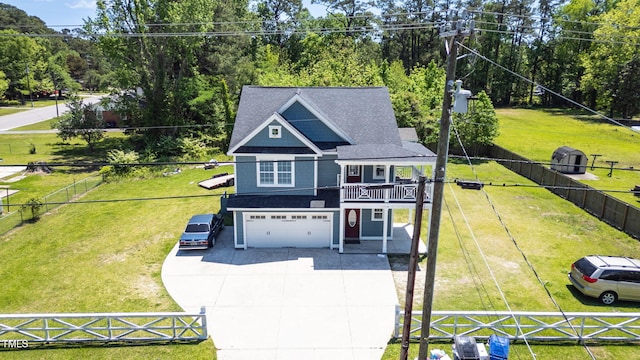 view of front of property featuring a garage, fence, a front yard, and concrete driveway