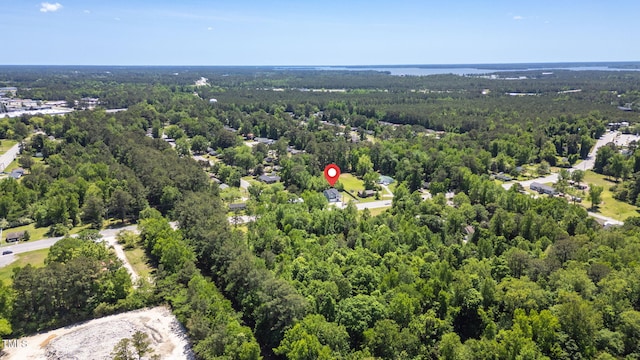 birds eye view of property with a forest view
