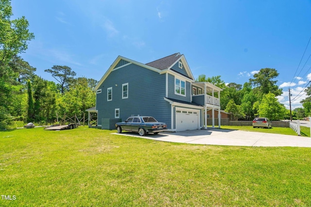 view of side of property featuring an attached garage, a lawn, fence, and driveway