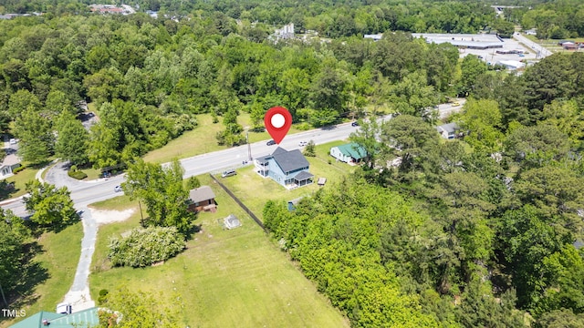 birds eye view of property with a view of trees