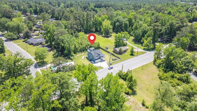 birds eye view of property with a wooded view