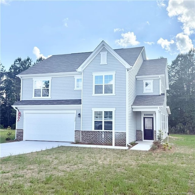132 Cahill, Home, Raeford, NC 28376 - view of front of home featuring a garage, driveway, a front lawn, and brick siding