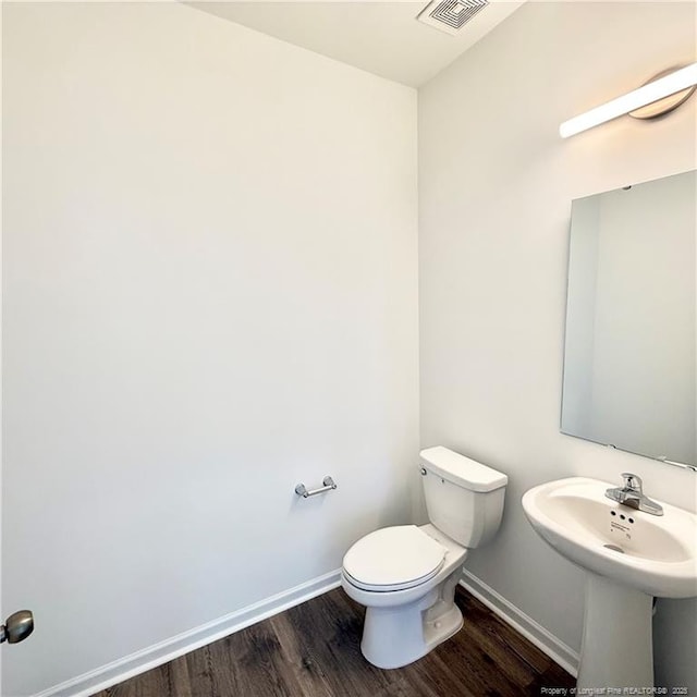 132 Cahill, Home, Raeford, NC 28376 - half bath with wood finished floors, baseboards, toilet, and a sink