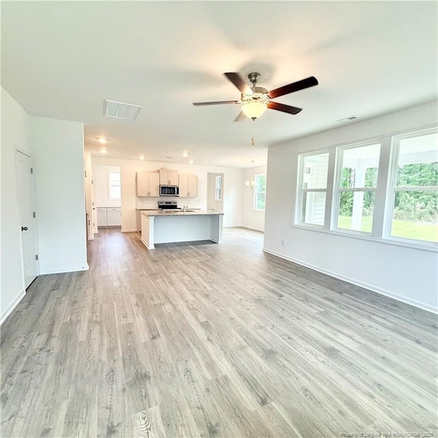 132 Cahill, Home, Raeford, NC 28376 - unfurnished living room with baseboards, light wood-style flooring, and a ceiling fan