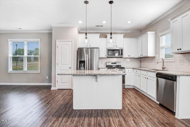 kitchen featuring dark wood-style floors, a healthy amount of sunlight, appliances with stainless steel finishes, and a sink
