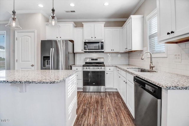 kitchen featuring a sink, white cabinetry, stainless steel appliances, and visible vents