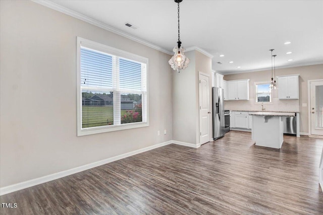 kitchen with crown molding, visible vents, stainless steel refrigerator with ice dispenser, open floor plan, and dark wood finished floors