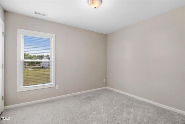 unfurnished room featuring visible vents, baseboards, and carpet floors