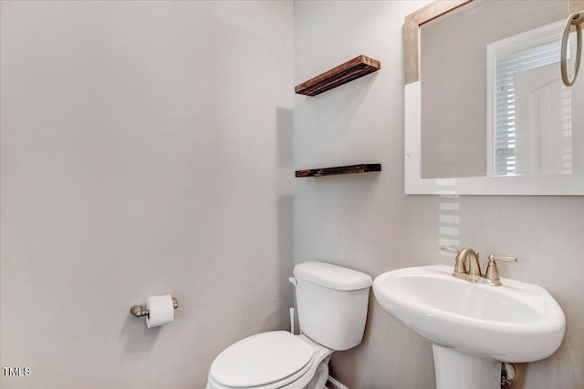 bathroom with toilet and a sink