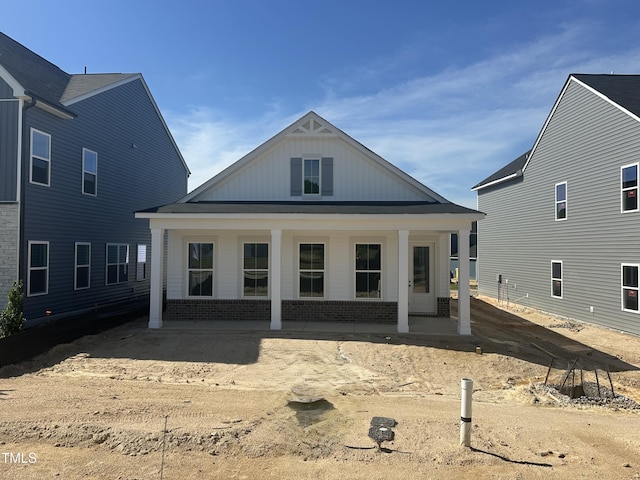 2874 Quarry Rd Unit 165, Rolesville, NC 27571 - rear view of house featuring brick siding, a porch, and board and batten siding