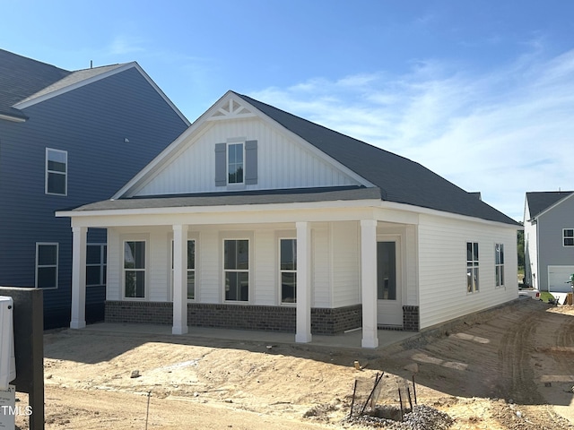 2874 Quarry Rd Unit 165, Rolesville, NC 27571 - rear view of house featuring brick siding, board and batten siding, and covered porch