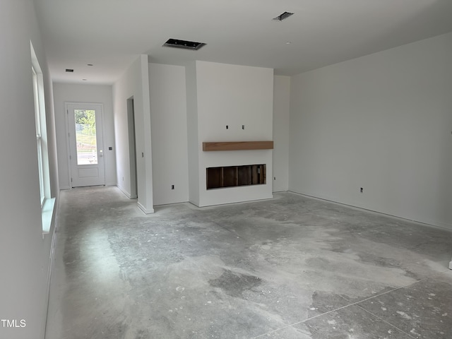 2874 Quarry Rd Unit 165, Rolesville, NC 27571 - unfurnished living room with unfinished concrete flooring and a fireplace