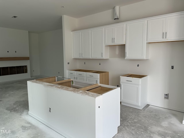 2874 Quarry Rd Unit 165, Rolesville, NC 27571 - kitchen featuring concrete floors, a center island, and white cabinetry
