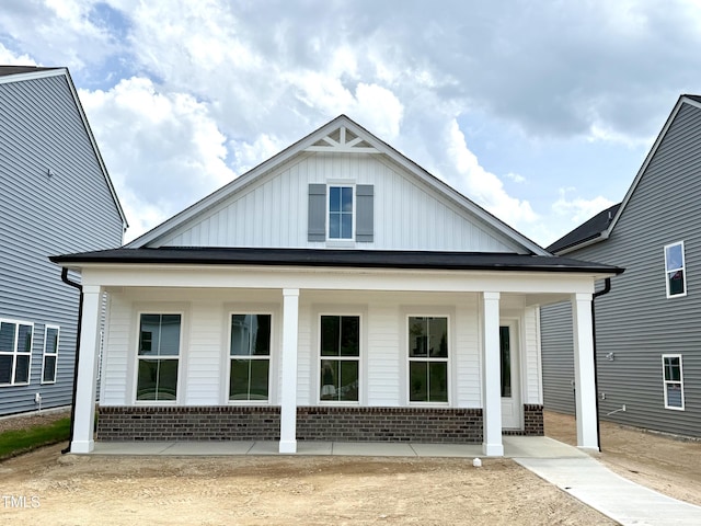 2874 Quarry Rd Unit 165, Rolesville, NC 27571 - view of front of home featuring a porch, brick siding, and board and batten siding