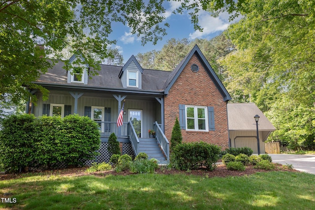 7901 Farnham Ct, Raleigh, NC 27615 - cape cod home with stairs, a garage, board and batten siding, a porch, and concrete driveway
