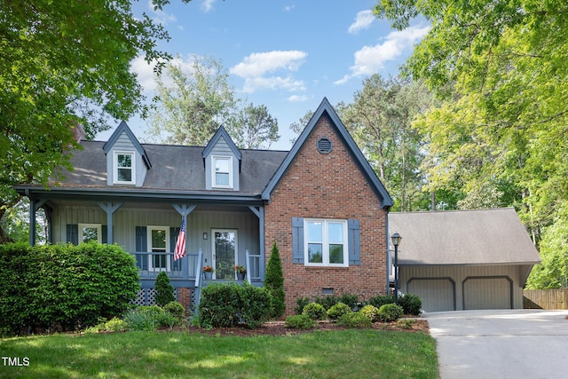 7901 Farnham Ct, Raleigh, NC 27615 - new england style home with covered porch, driveway, a front yard, brick siding, and an attached garage
