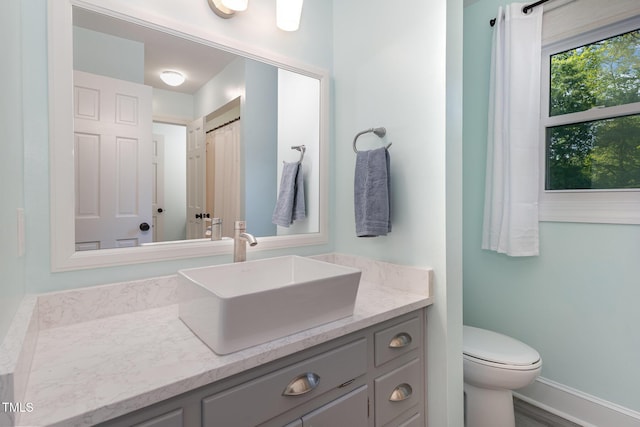 7901 Farnham Ct, Raleigh, NC 27615 - bathroom with toilet, baseboards, and vanity