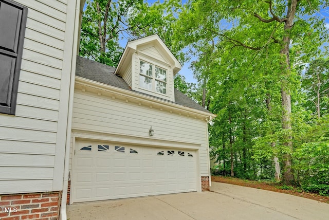 garage featuring concrete driveway