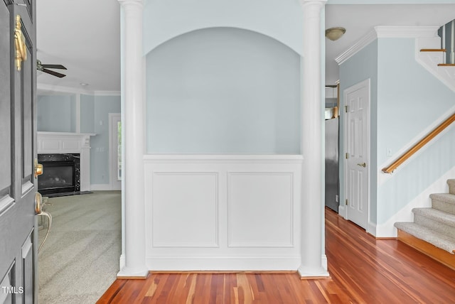 corridor featuring stairway, decorative columns, and crown molding