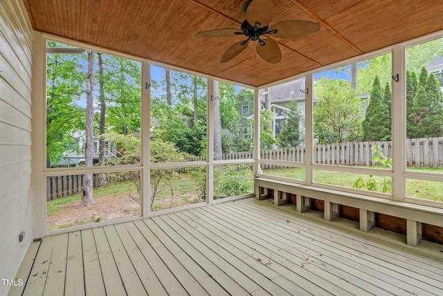 unfurnished sunroom with ceiling fan