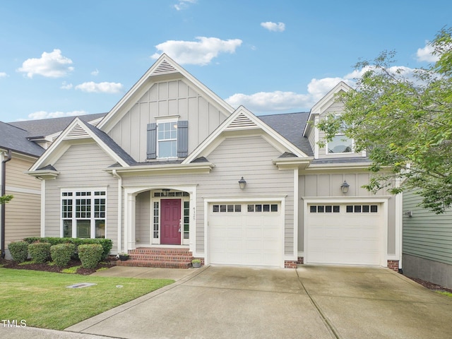 4125 Enfield Ridge Dr, Cary, NC 27519 - view of front of house with board and batten siding, driveway, a garage, and a front yard