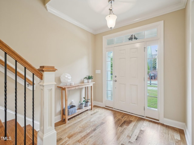 4125 Enfield Ridge Dr, Cary, NC 27519 - entryway featuring ornamental molding, wood finished floors, stairway, and baseboards