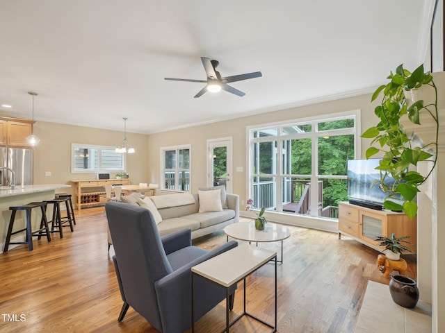 4125 Enfield Ridge Dr, Cary, NC 27519 - living area featuring plenty of natural light, crown molding, a chandelier, ceiling fan, and light wood finished floors
