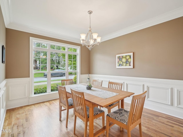 4125 Enfield Ridge Dr, Cary, NC 27519 - dining space with ornamental molding, wainscoting, a chandelier, light wood-type flooring, and a decorative wall