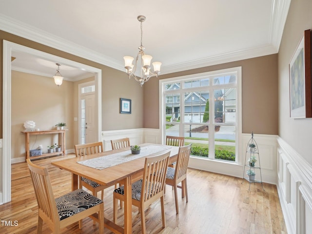 4125 Enfield Ridge Dr, Cary, NC 27519 - dining area with light wood finished floors, ornamental molding, wainscoting, a decorative wall, and a chandelier
