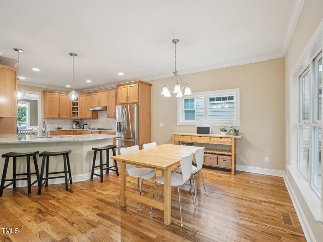 4125 Enfield Ridge Dr, Cary, NC 27519 - dining space with ornamental molding, light wood-style flooring, a chandelier, recessed lighting, and baseboards