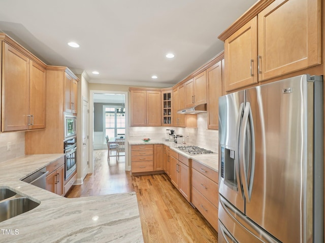 4125 Enfield Ridge Dr, Cary, NC 27519 - kitchen with stainless steel appliances, light stone countertops, ornamental molding, light wood-style floors, and decorative backsplash