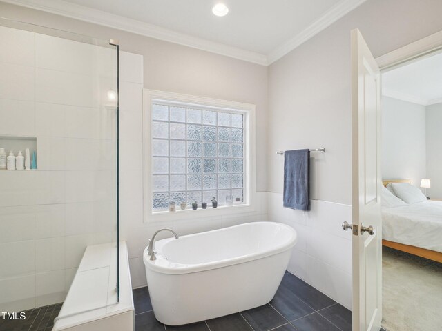 4125 Enfield Ridge Dr, Cary, NC 27519 - full bathroom featuring a soaking tub, ensuite bath, crown molding, tile walls, and tile patterned floors