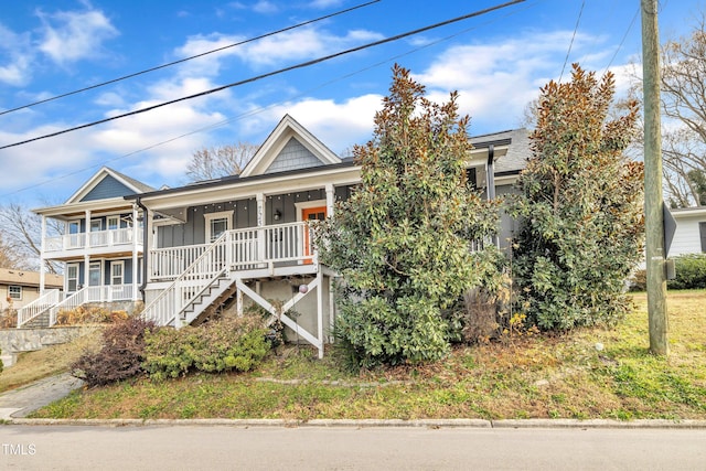 725 S State St, Raleigh, NC 27601 - view of front of home featuring board and batten siding, a porch, and stairs